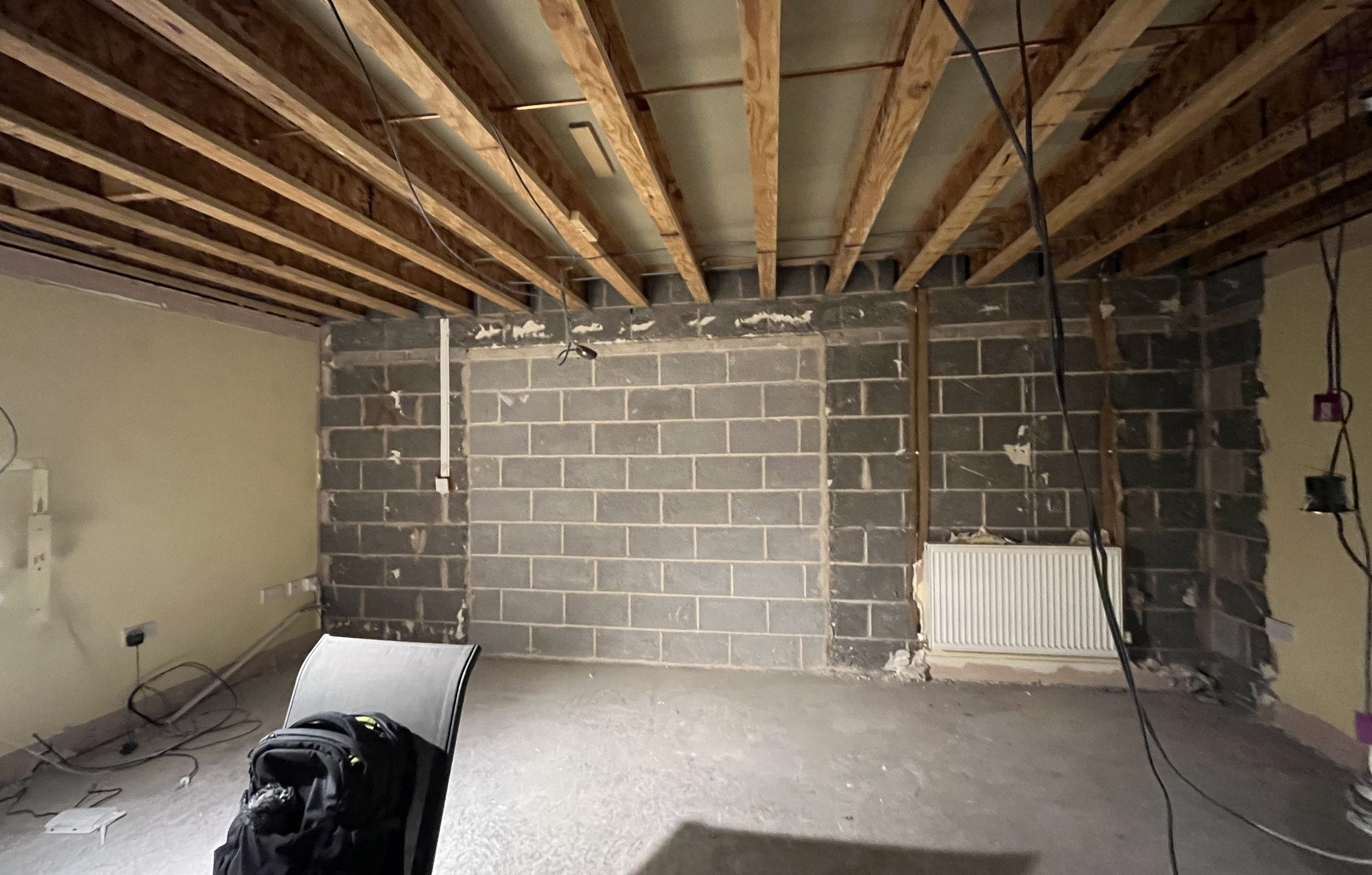 The bare shell before fit-out, blockwork and joists exposed