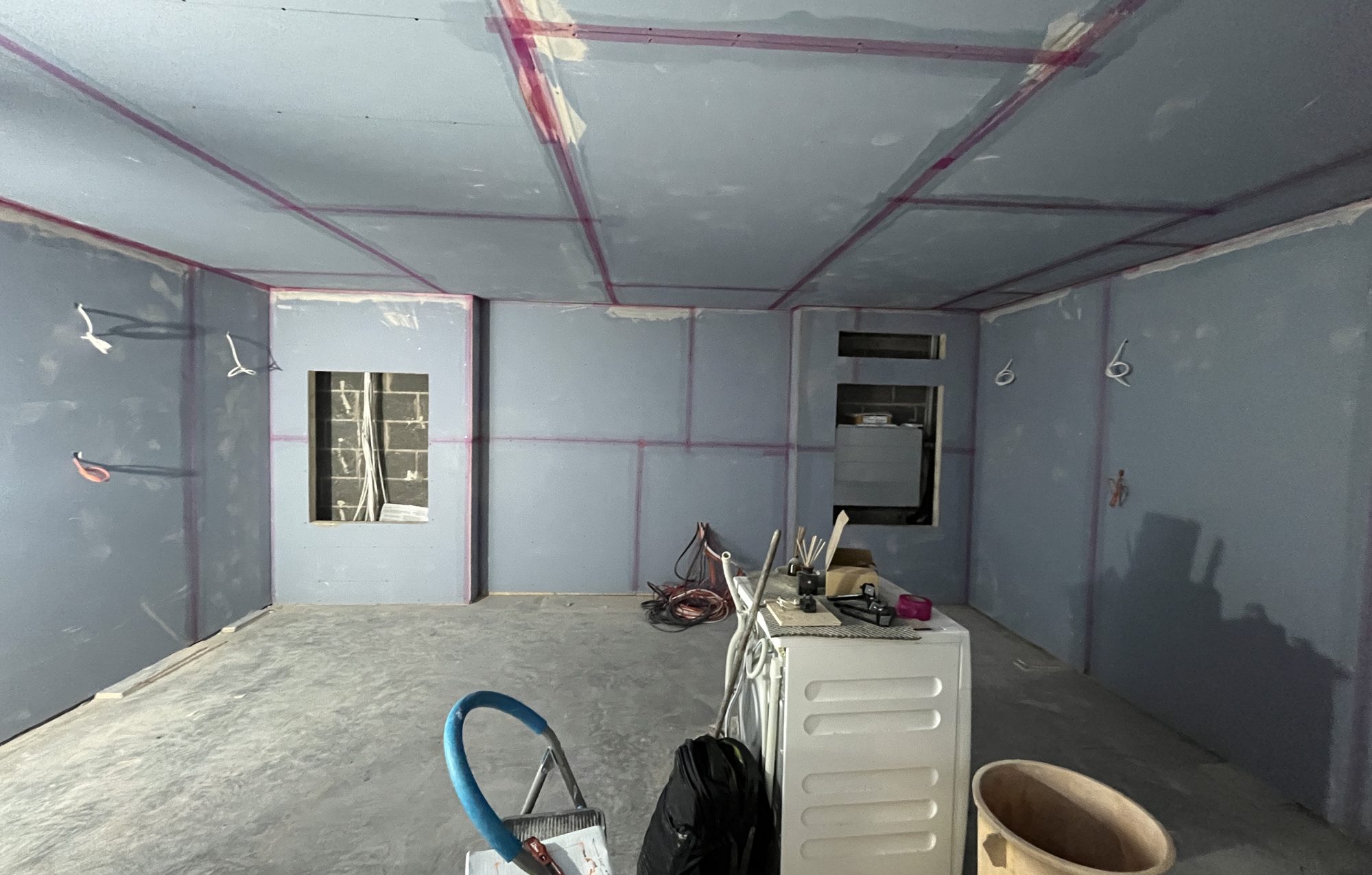The room lined with sound-blocking plasterboard during the build