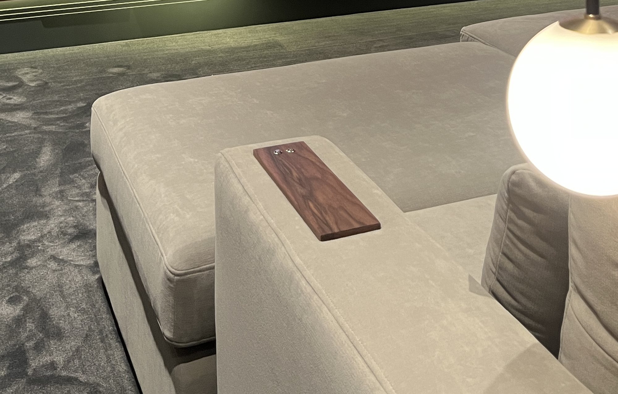 Solid walnut control inlay set flush into the seating arm, with controls in the timber