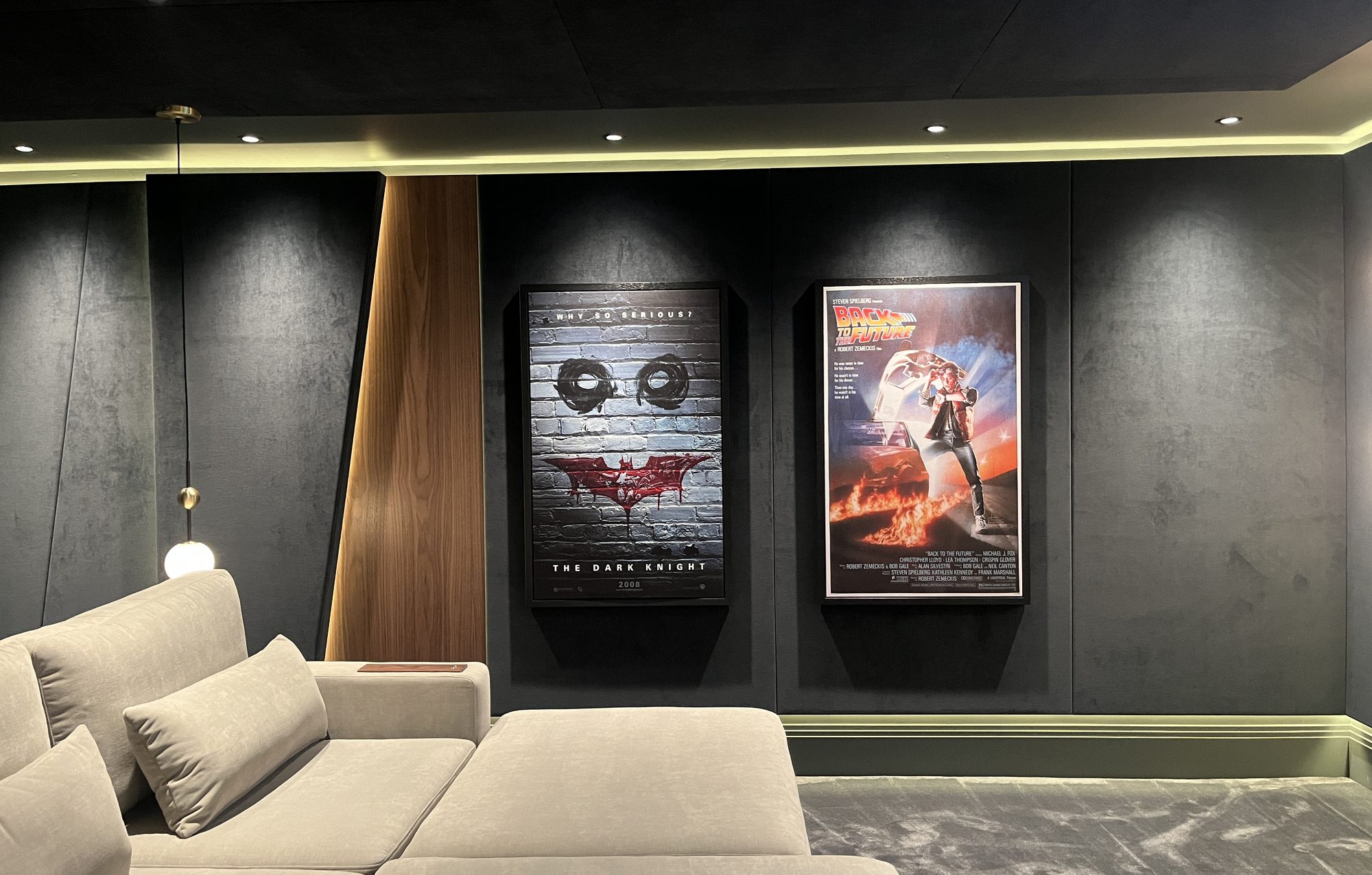 Framed printed velvet acoustic panels on the cinema wall