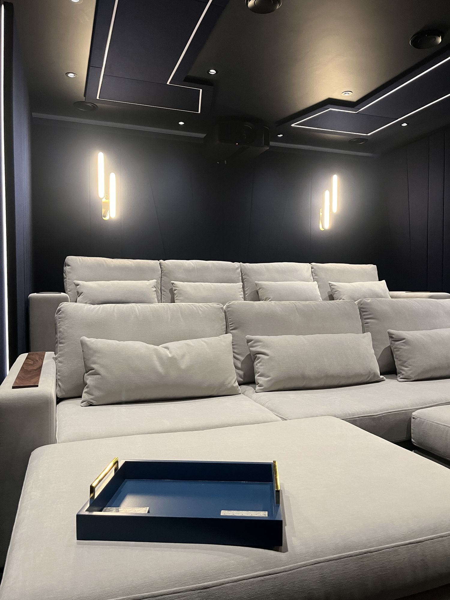 The raised back row with a brass task lamp on the armrest