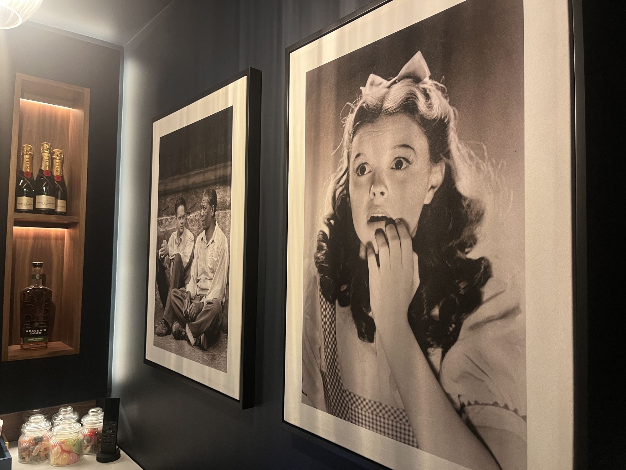 A gallery wall of framed black-and-white film portraits in the cinema lobby